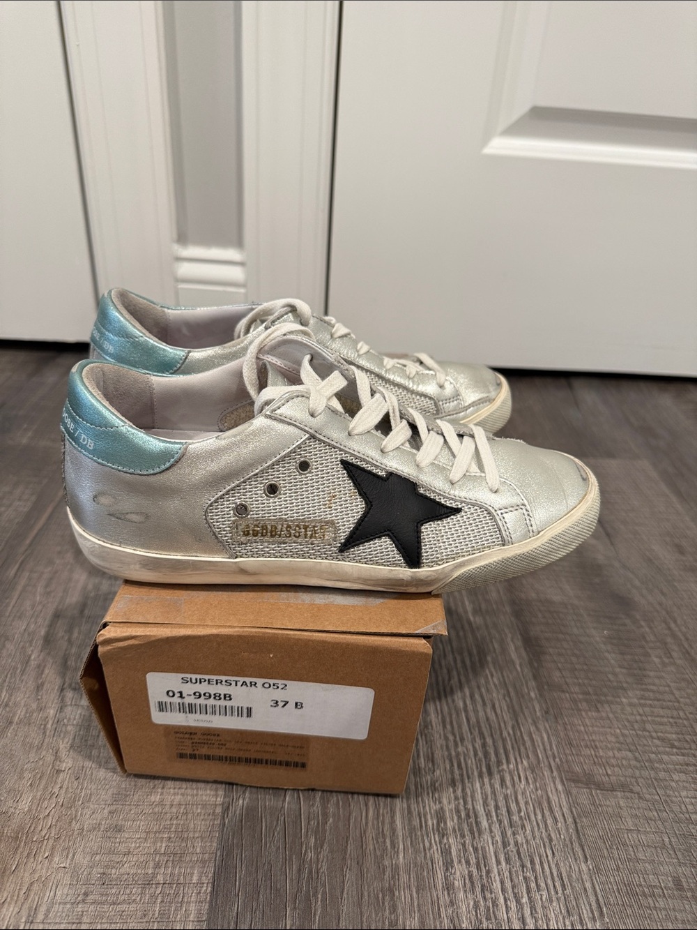 Metallic Silver Golden Goose Sneakers with Black Star Accent